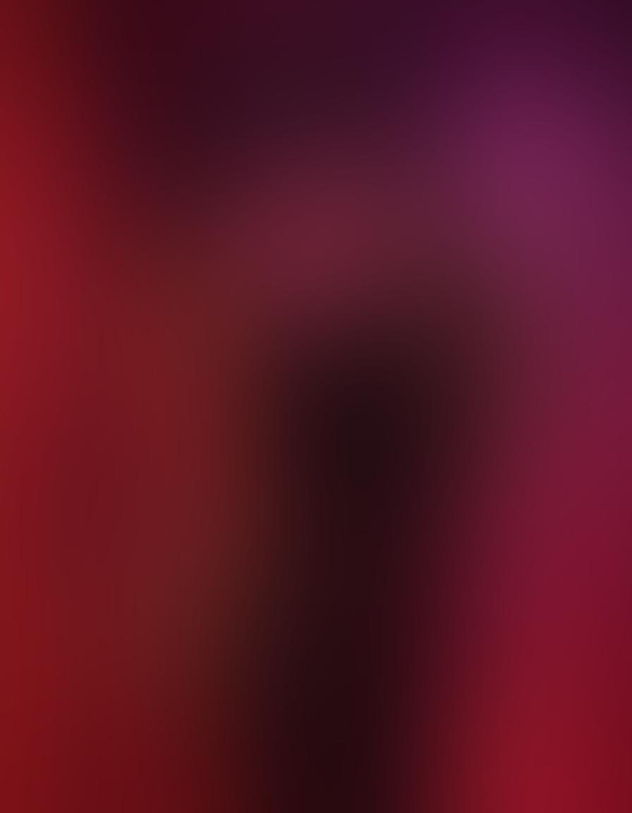 A provocative scene featuring a sultry silhouette of a couple entwined in an intimate pose, surrounded by blurred neon lights creating an alluring atmosphere. The background hints at a glamorous adult entertainment setting with plush red velvet textures and soft, dim lighting that evokes a sense of mystery and desire. Add splashes of deep, rich colors to enhance the sensuality while maintaining an artistic touch. super-realistic. vibrant colors. soft focus.